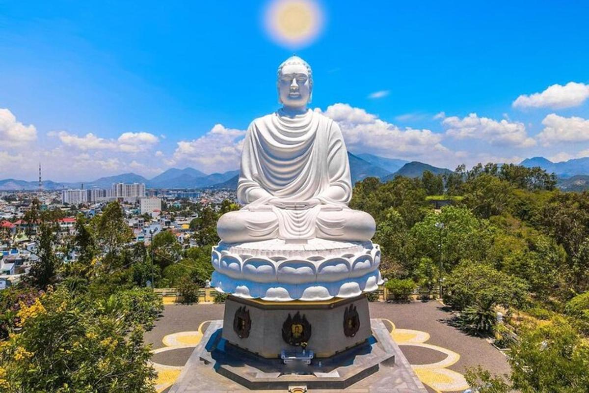a large statue of a buddha sitting in a park