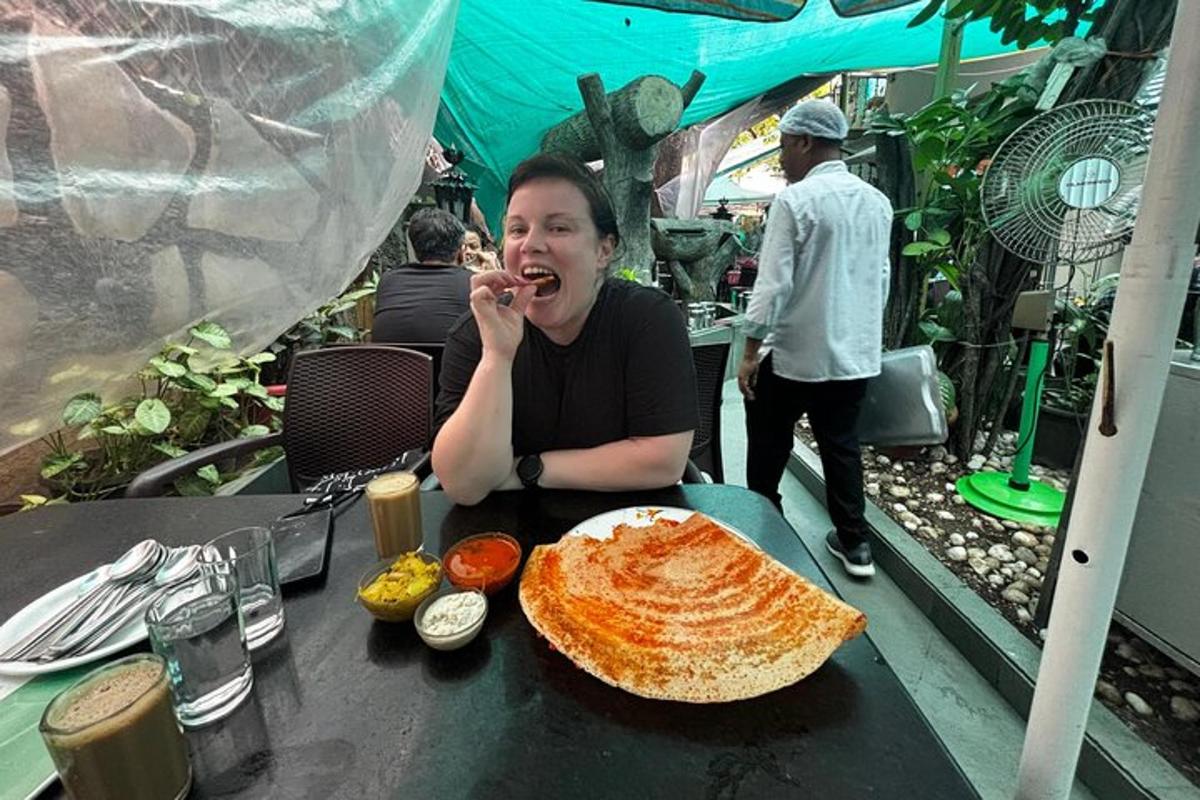 a woman sitting at a table with a plate of food