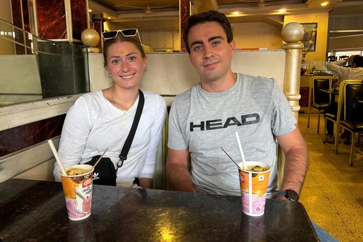 a man and a woman sitting at a table with drinks