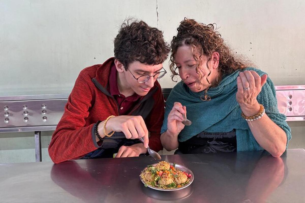 a man and woman sitting at a table eating food
