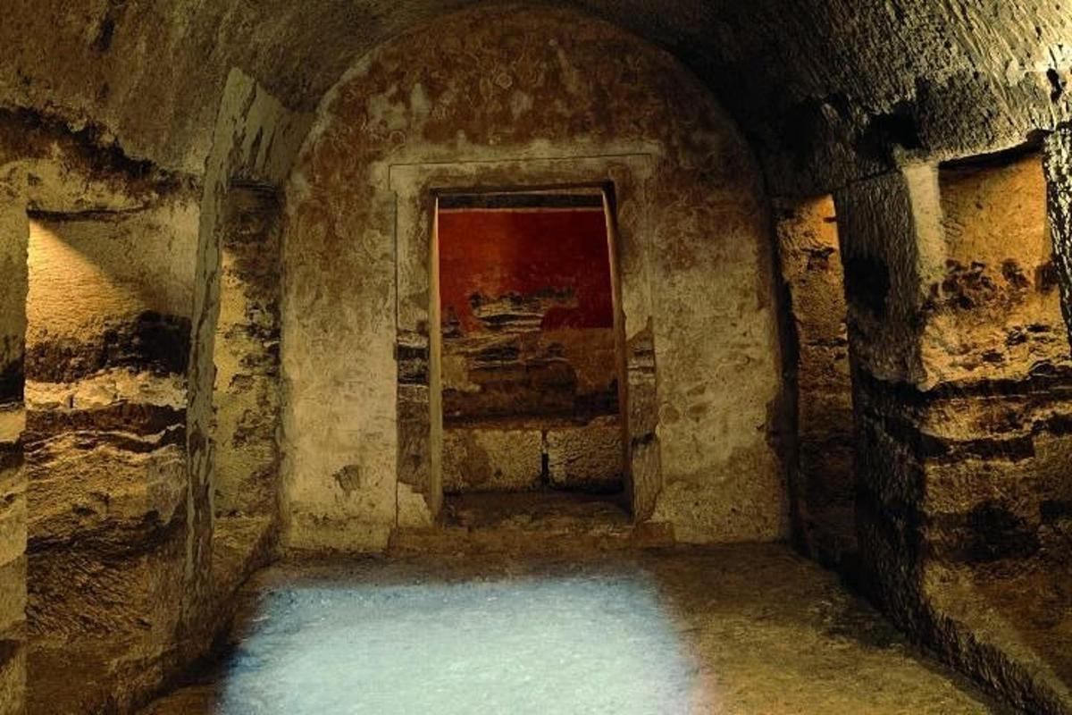a dark room with a tunnel with water in it