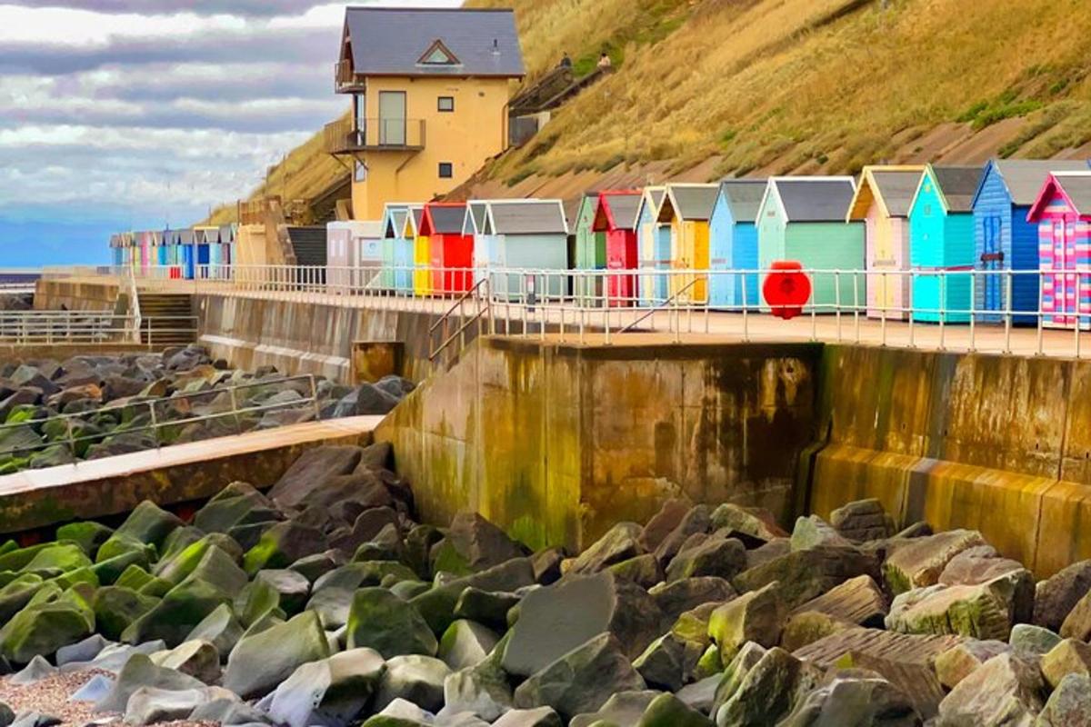 a row of colorful beach huts on a pier