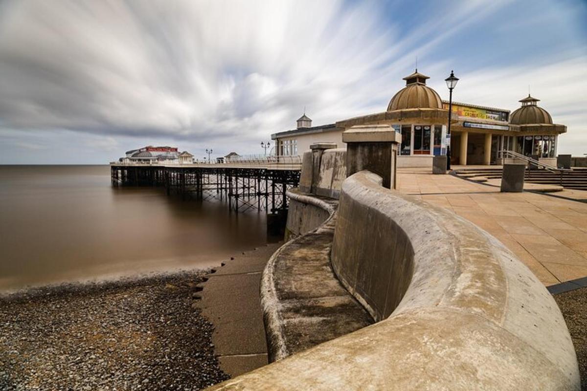 a pier with a building next to the water