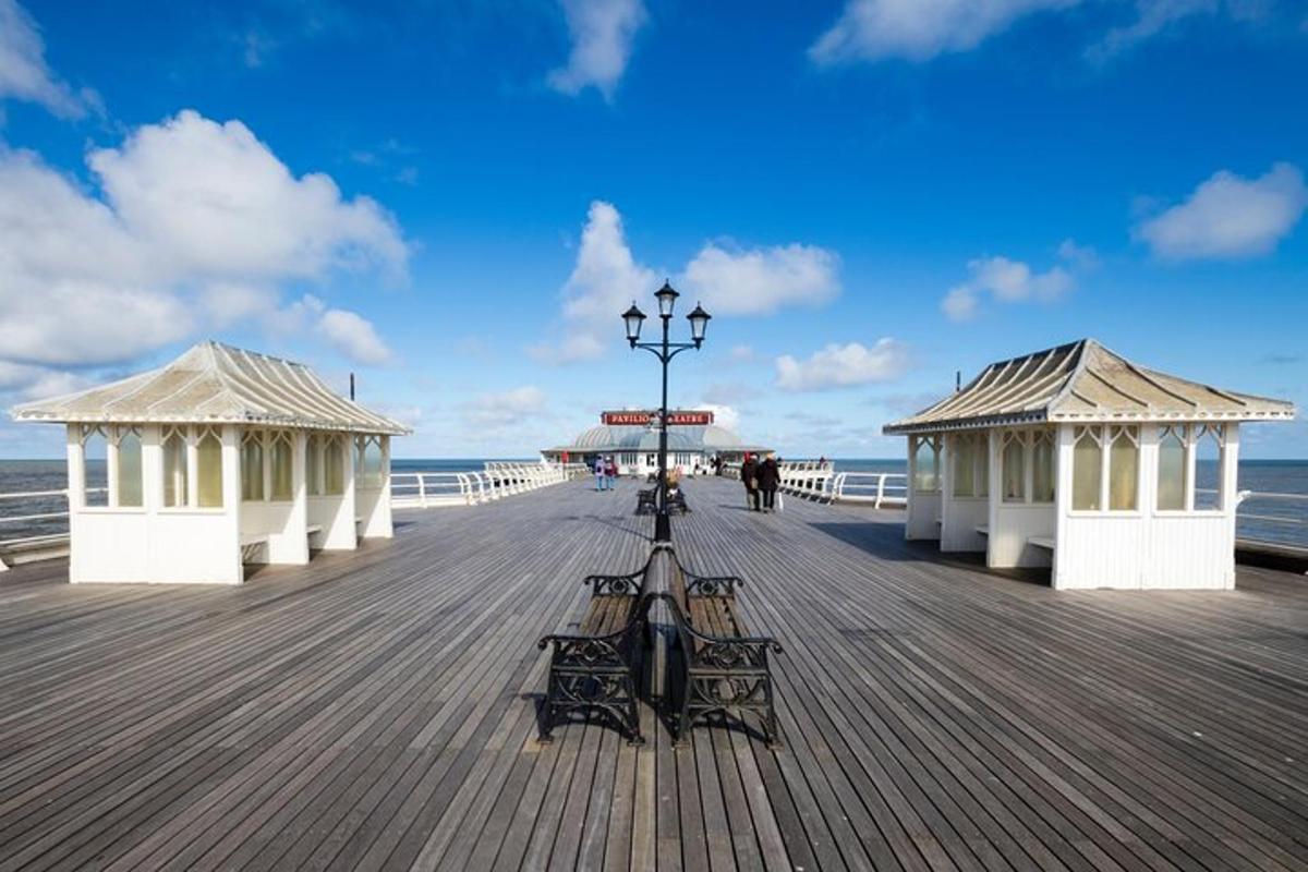 a pier with benches and a street light on it