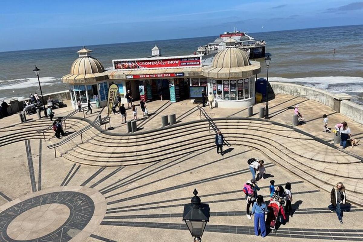 a group of people walking on the stairs near the ocean
