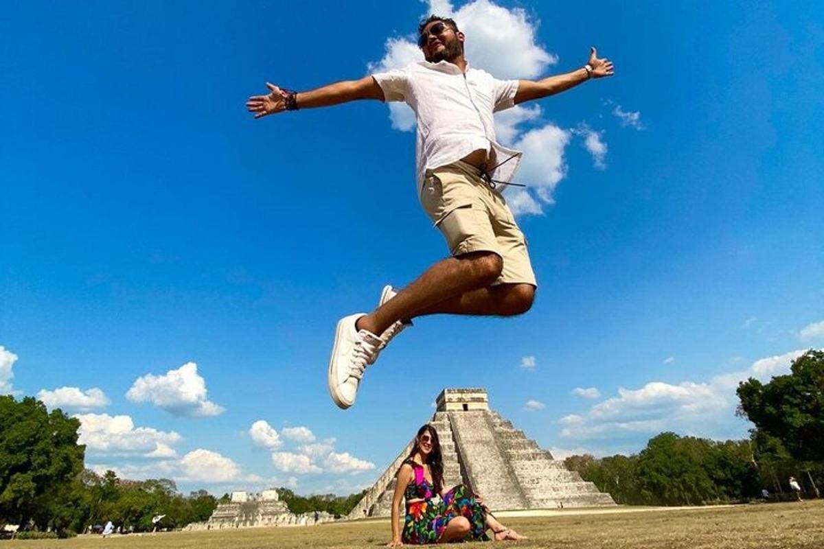 a man jumping in the air in front of a pyramid