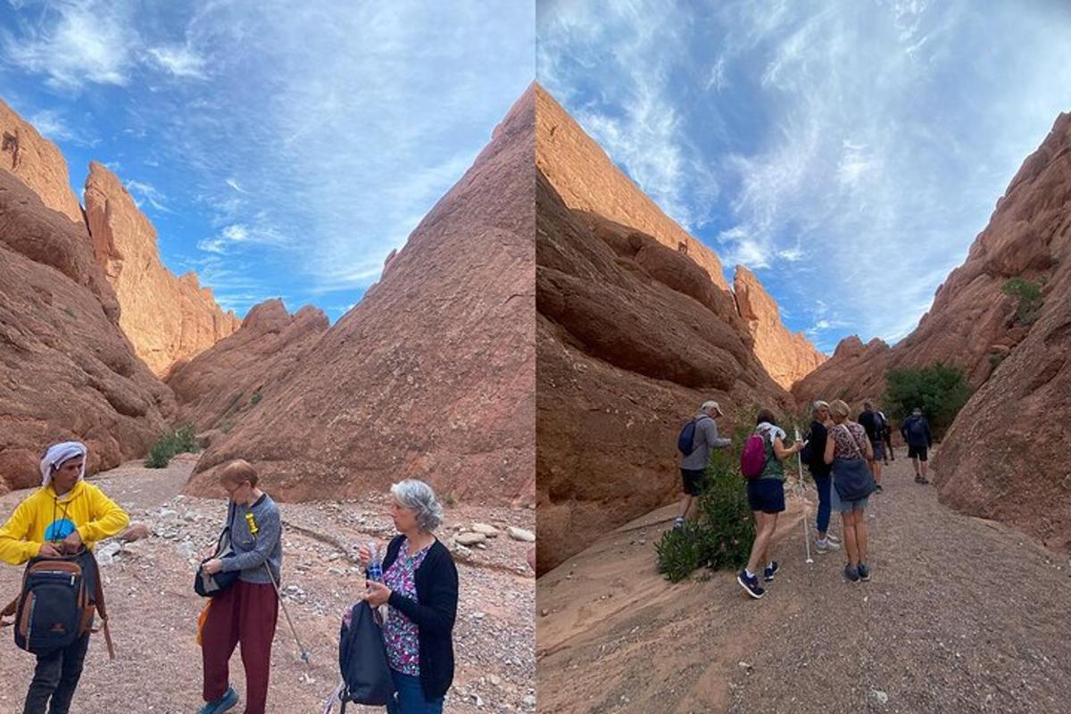 a group of people walking through a canyon