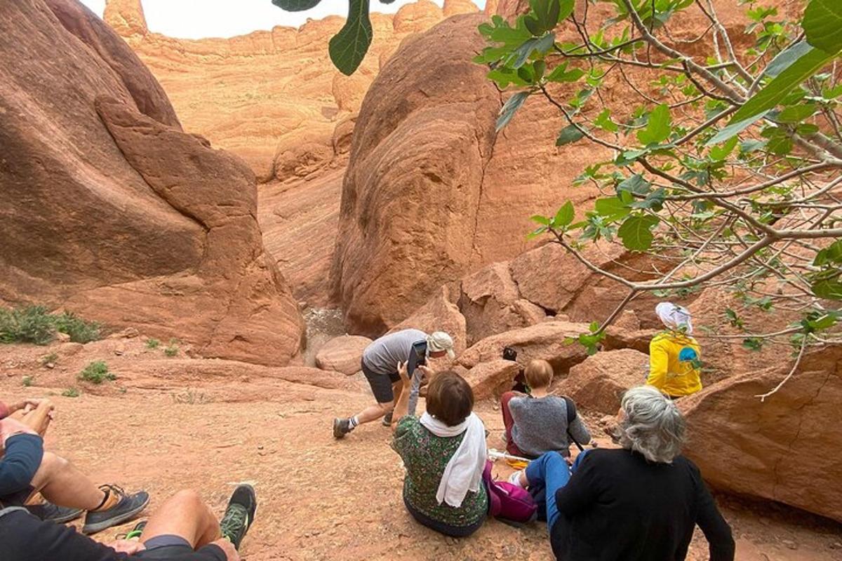 a group of people sitting on the side of a canyon
