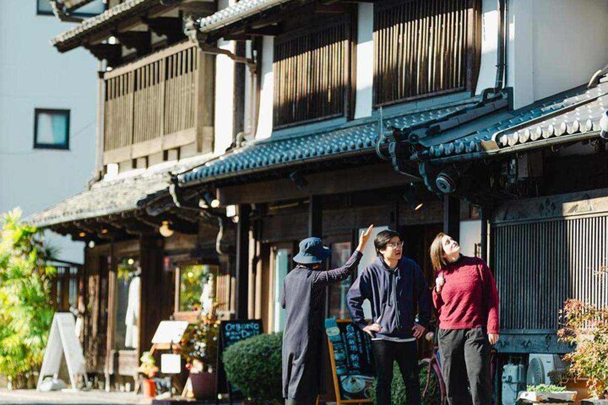 a group of three people standing outside of a building