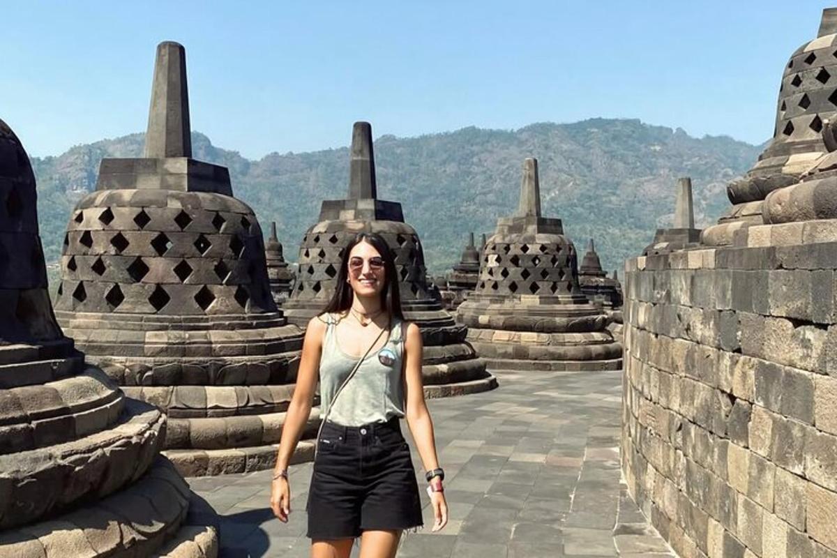 a woman standing in front of a temple