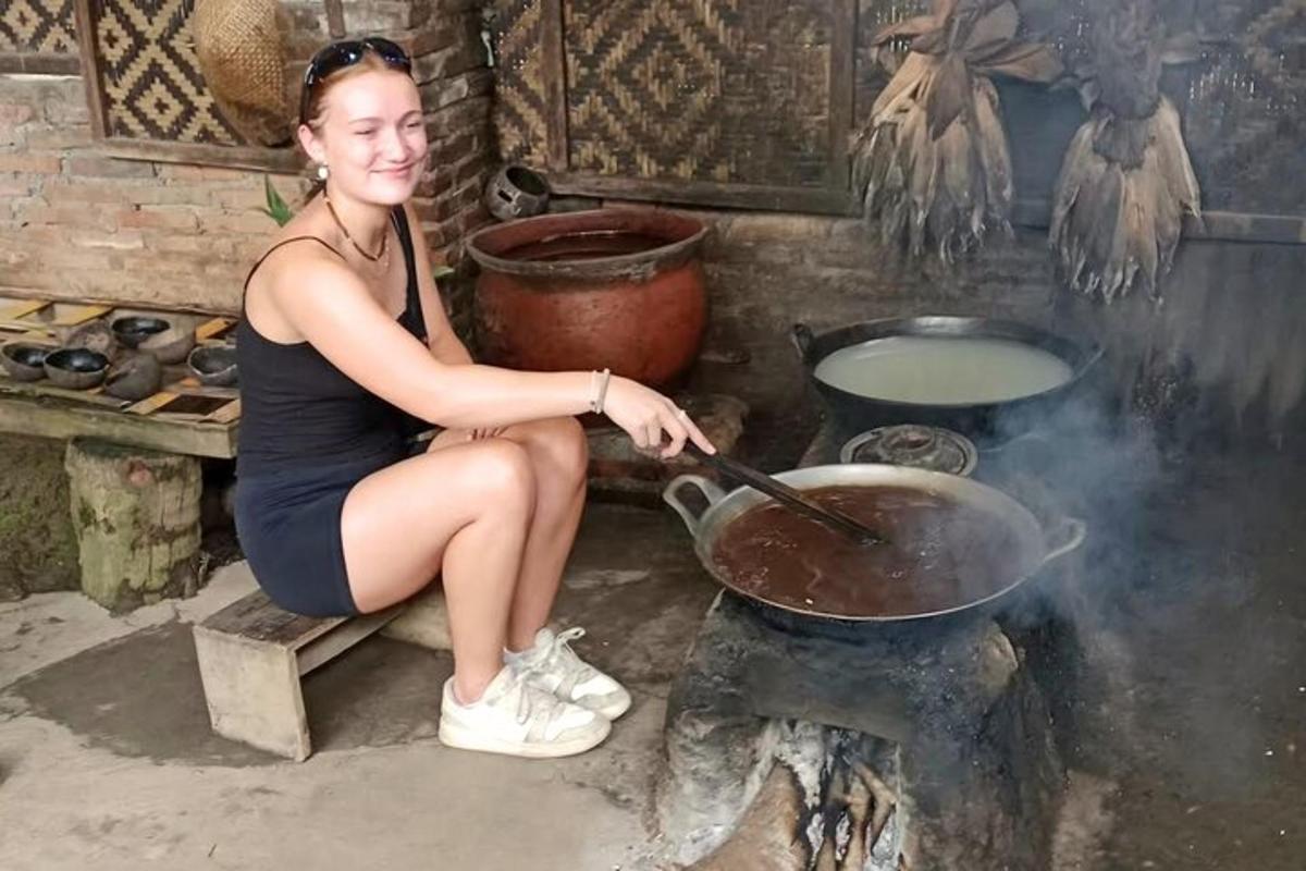 a woman is cooking in a wok