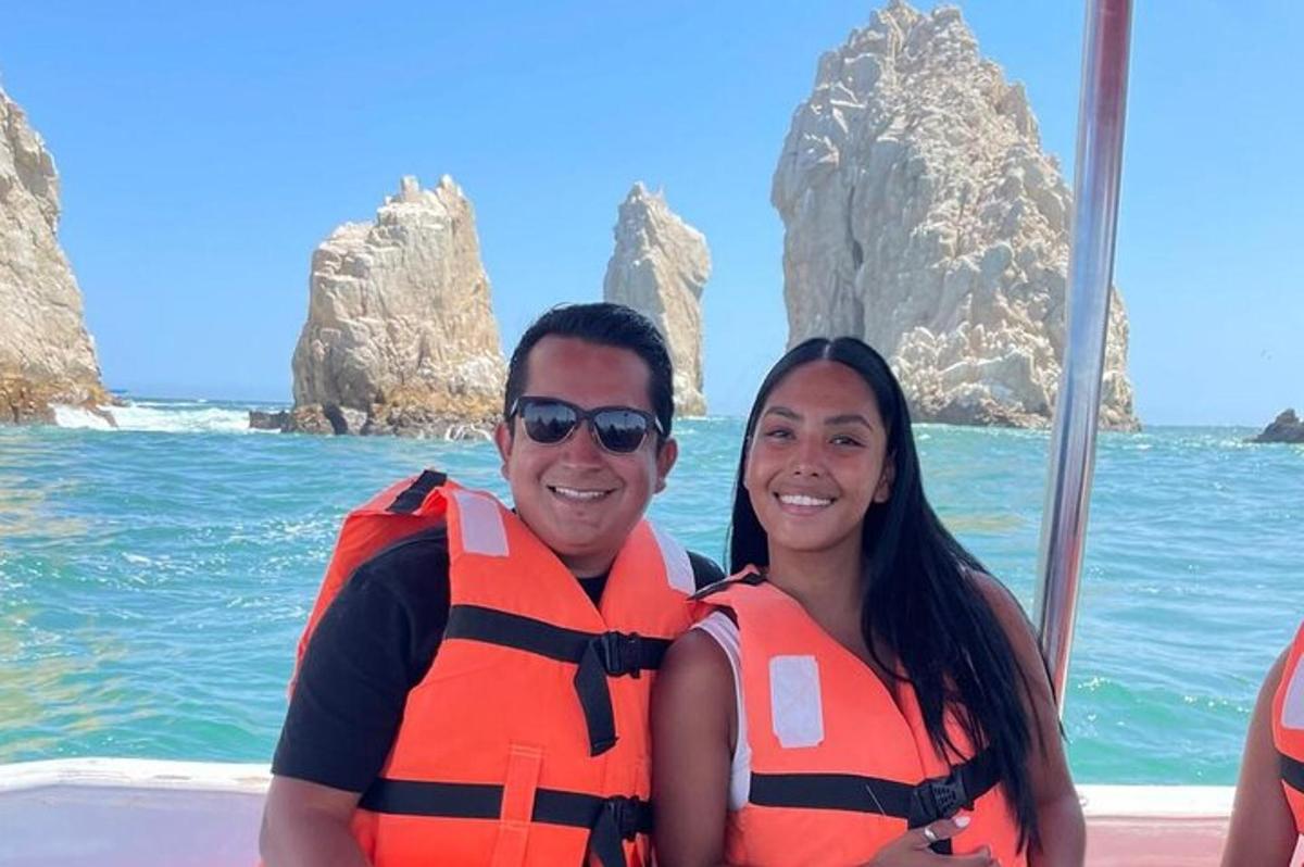 a man and a woman wearing life jackets on a boat