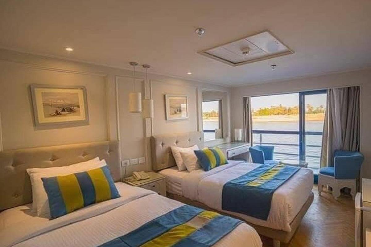 a hotel room with two beds and a window