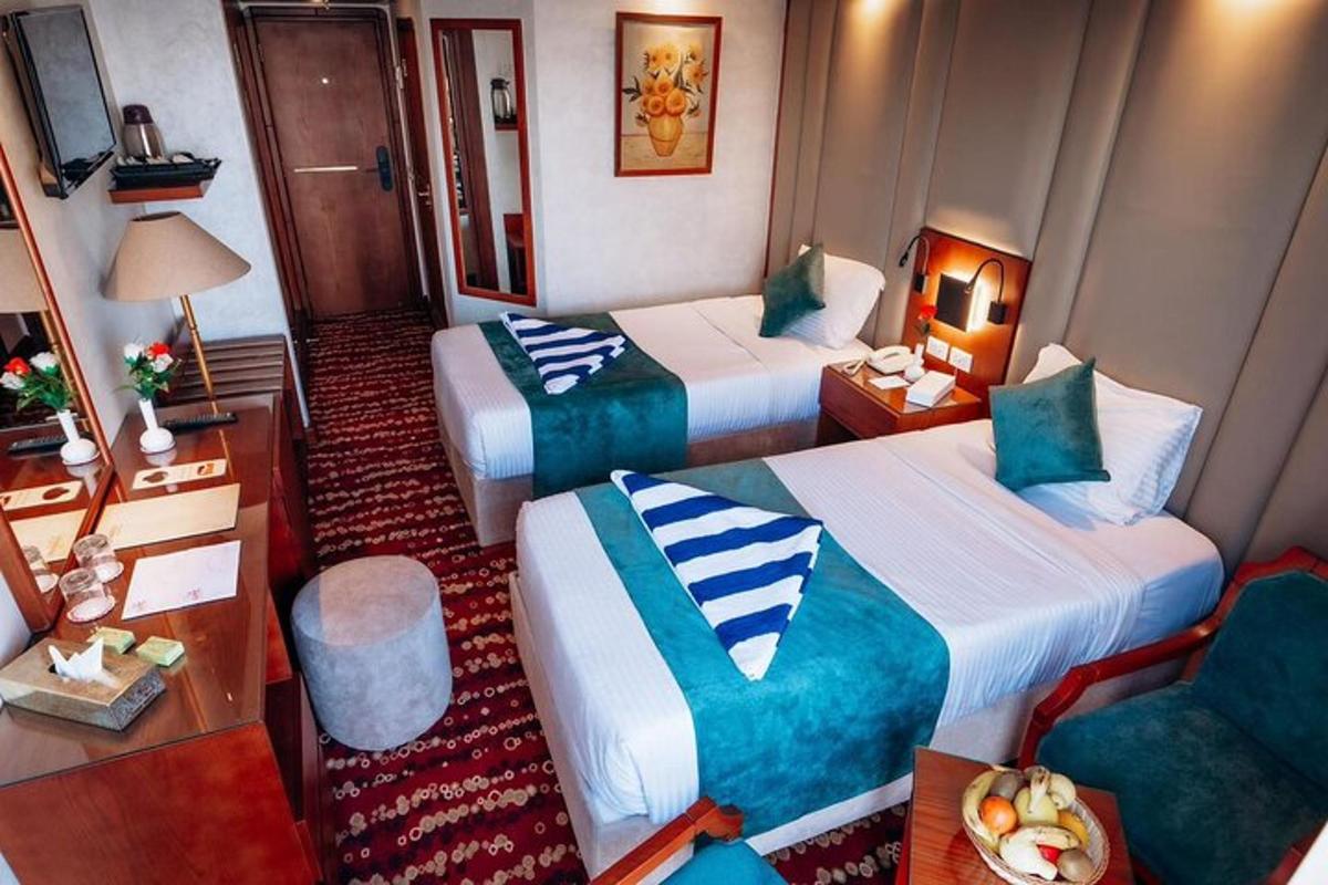 a hotel room with two beds and a desk