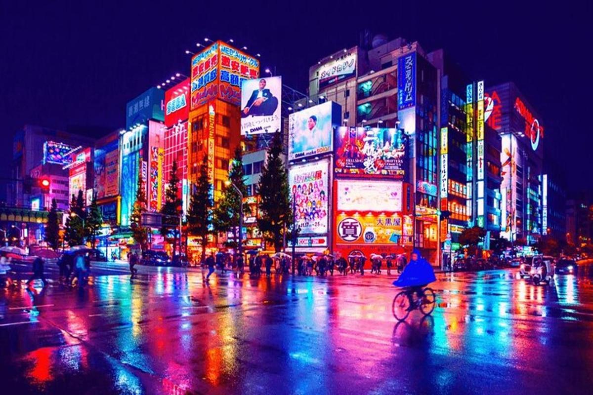 a busy city street at night with people and buildings