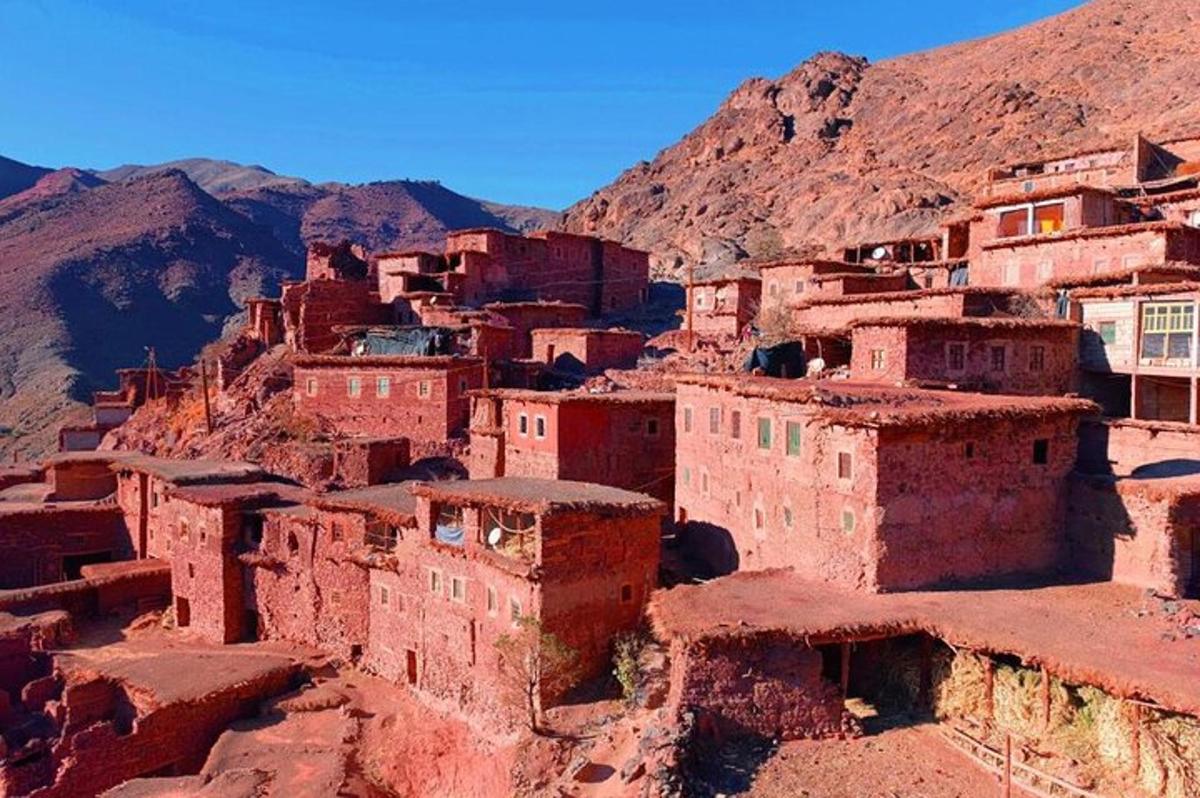 a village in the desert with mountains in the background