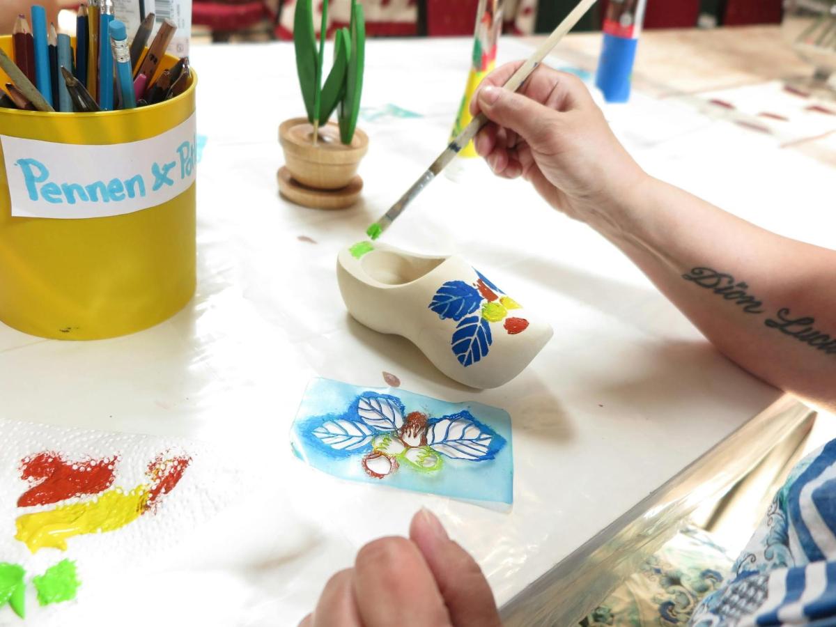 a person painting a flower on a table