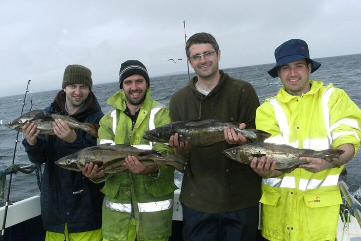 a group of men holding up a large fish