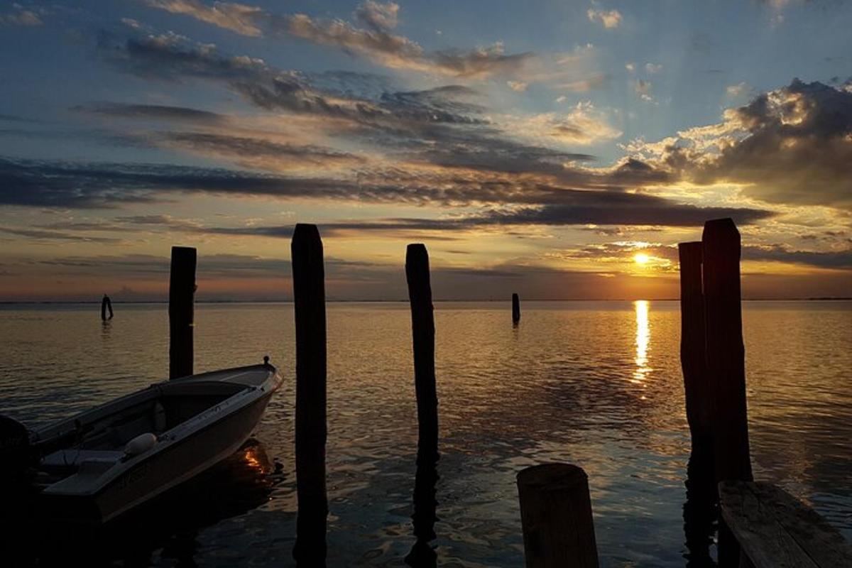 a boat in the water at a dock with a sunset
