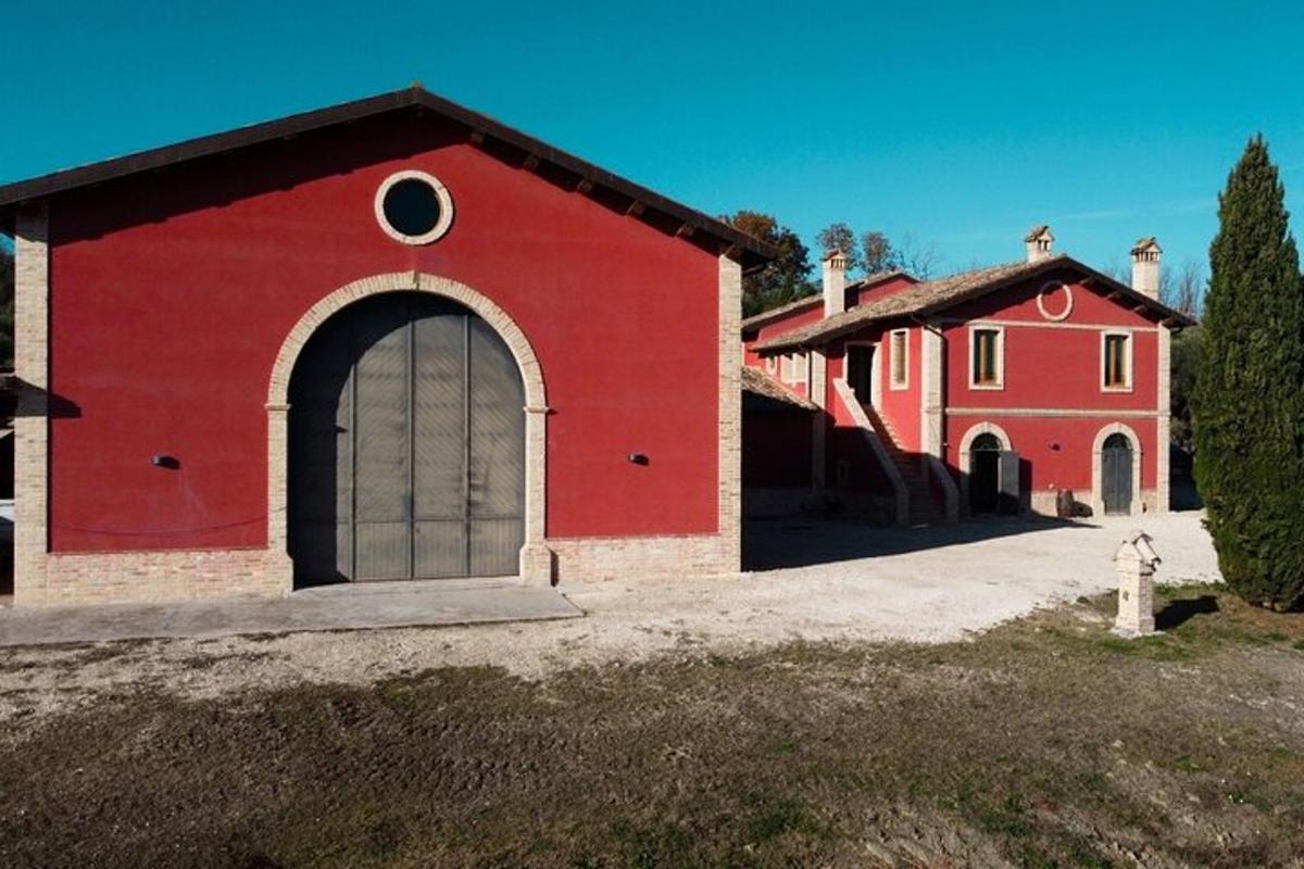 a red building with a large door and a fire hydrant