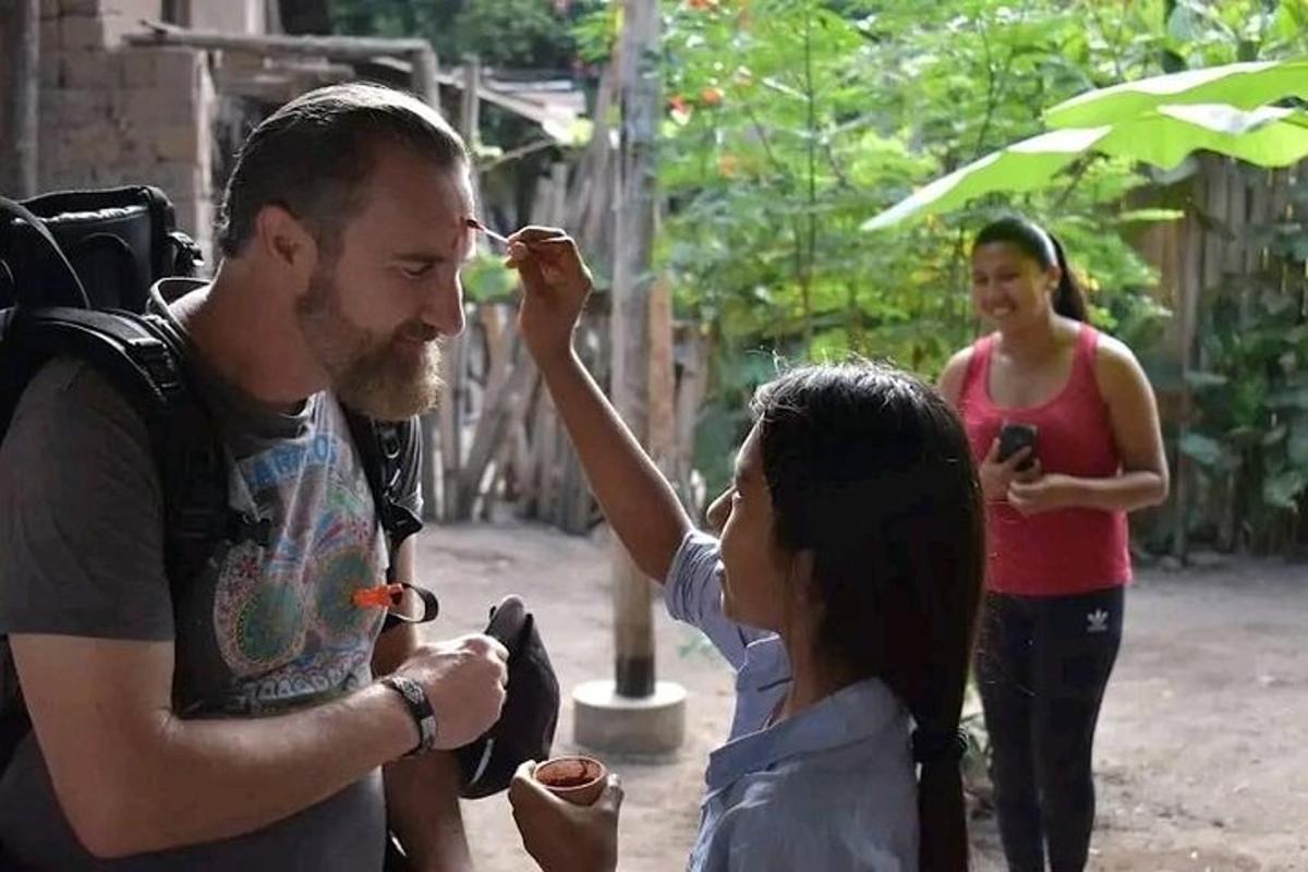 sekelompok orang berdiri di sekitar seorang pria yang sedang memberi makan seorang wanita