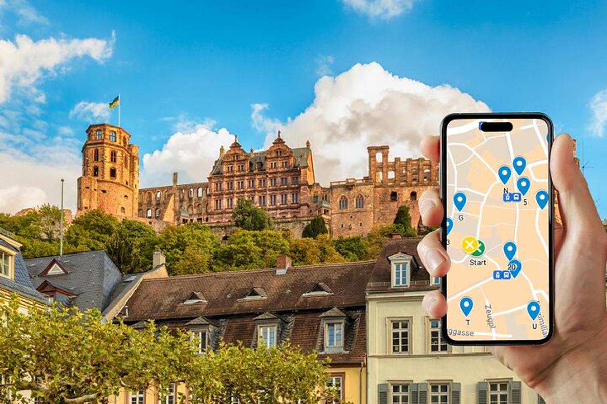 osoba držící mobilní telefon před hradem