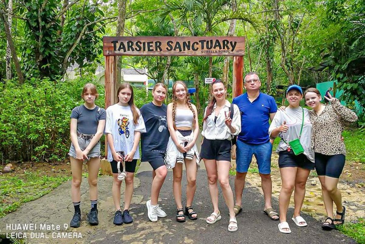 a group of people standing in front of a sign