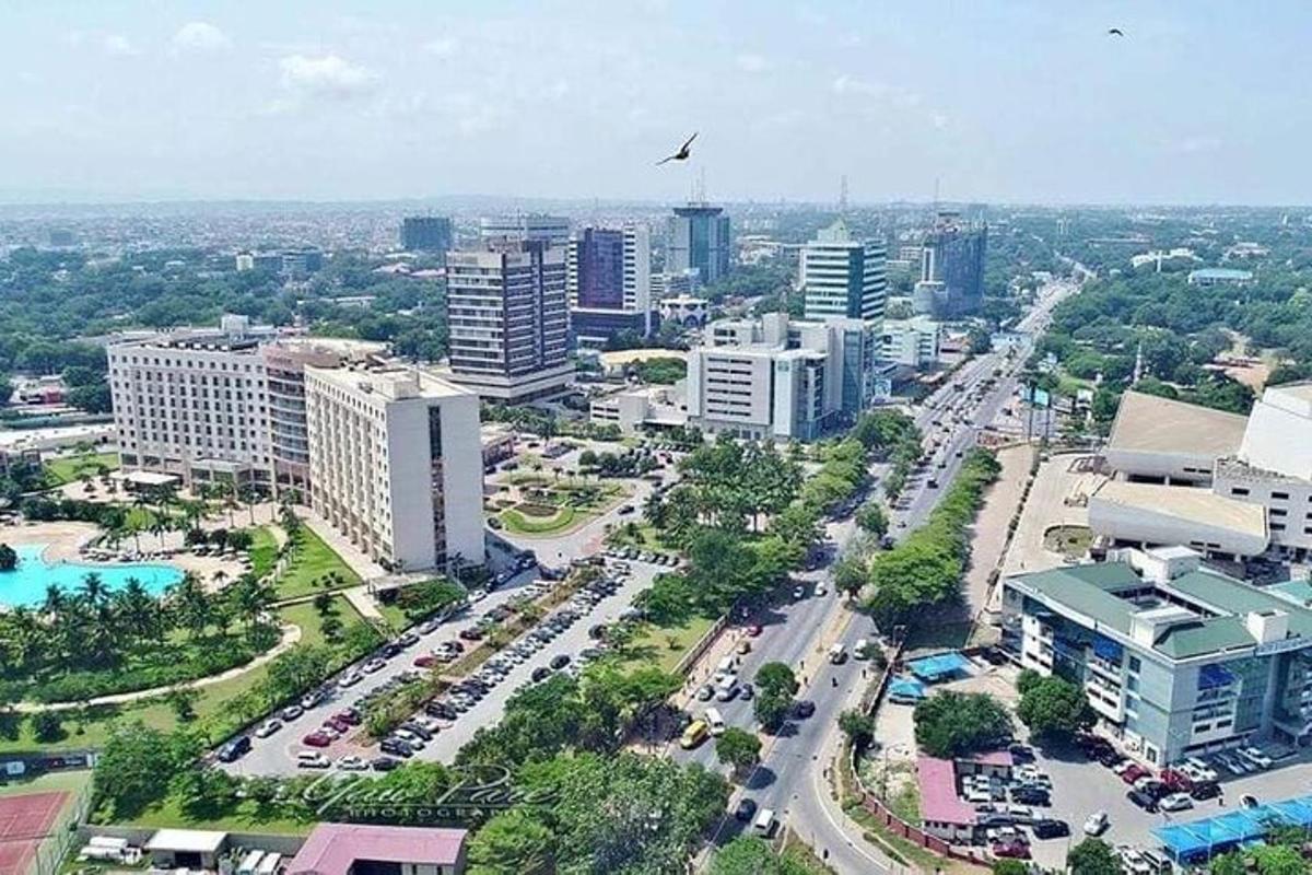 an aerial view of a city with buildings and cars