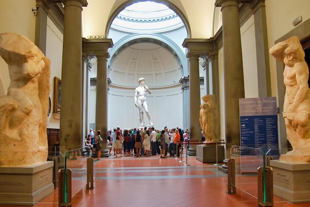 a group of people looking at a statue in a museum
