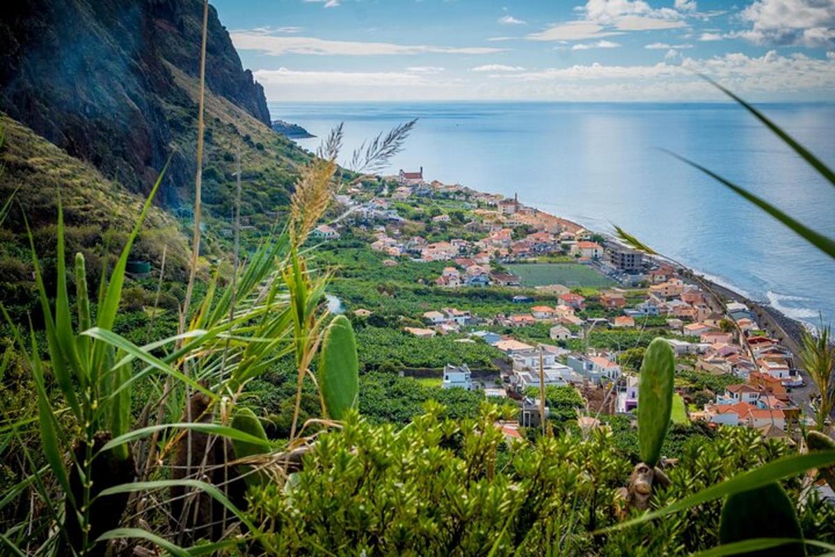 a town on the side of a hill next to the water