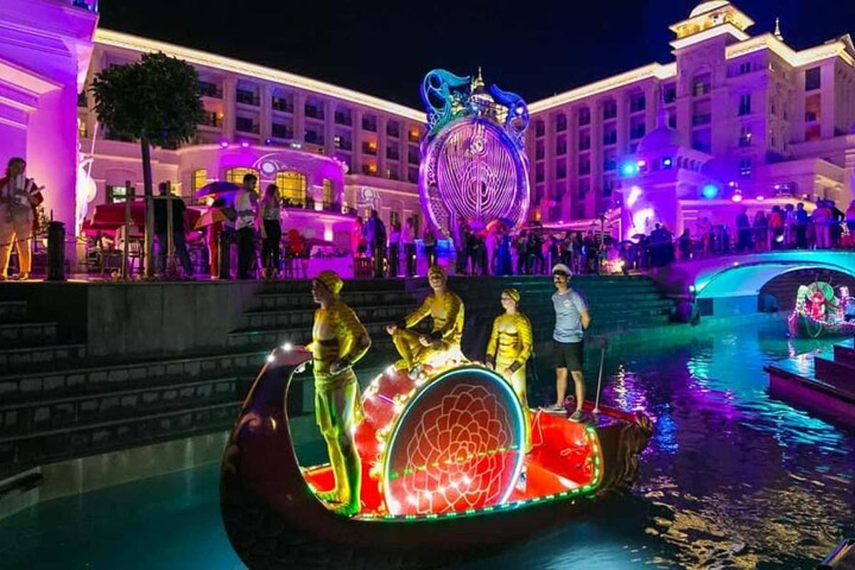 a group of people in a boat in the water at night