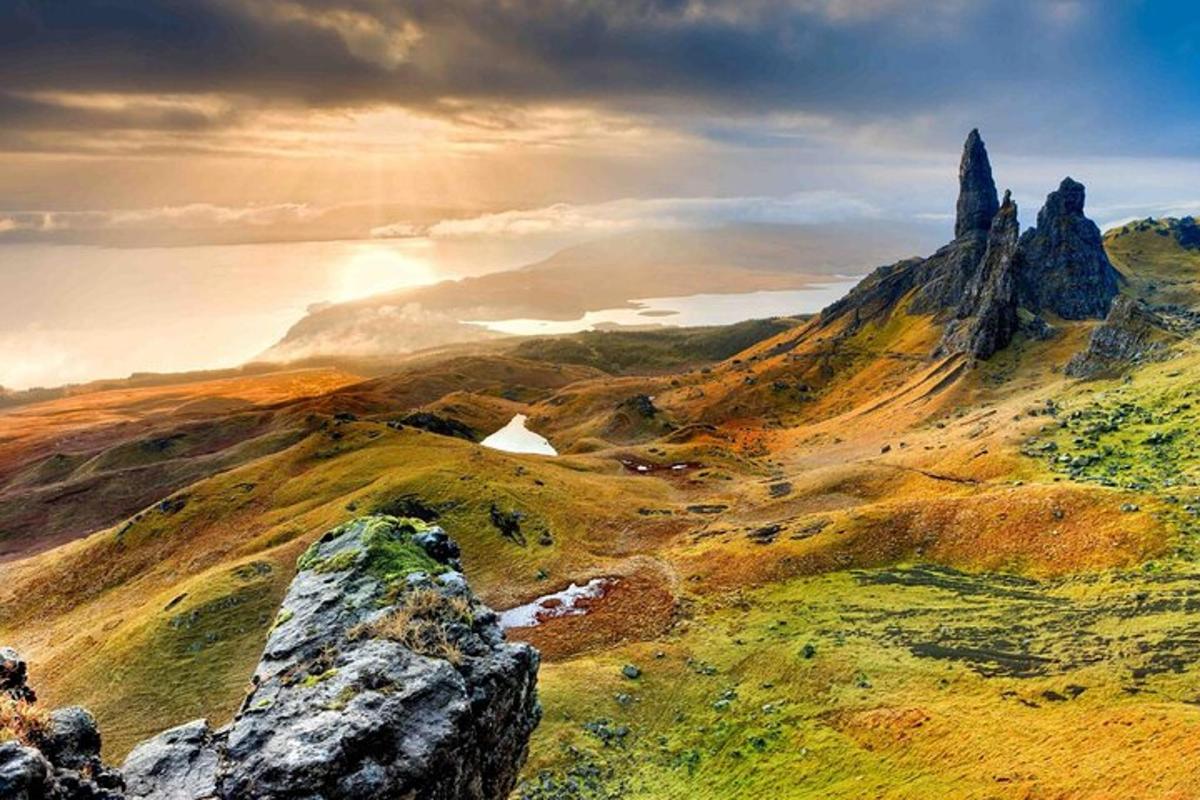 a view of a mountain with rocks in the foreground
