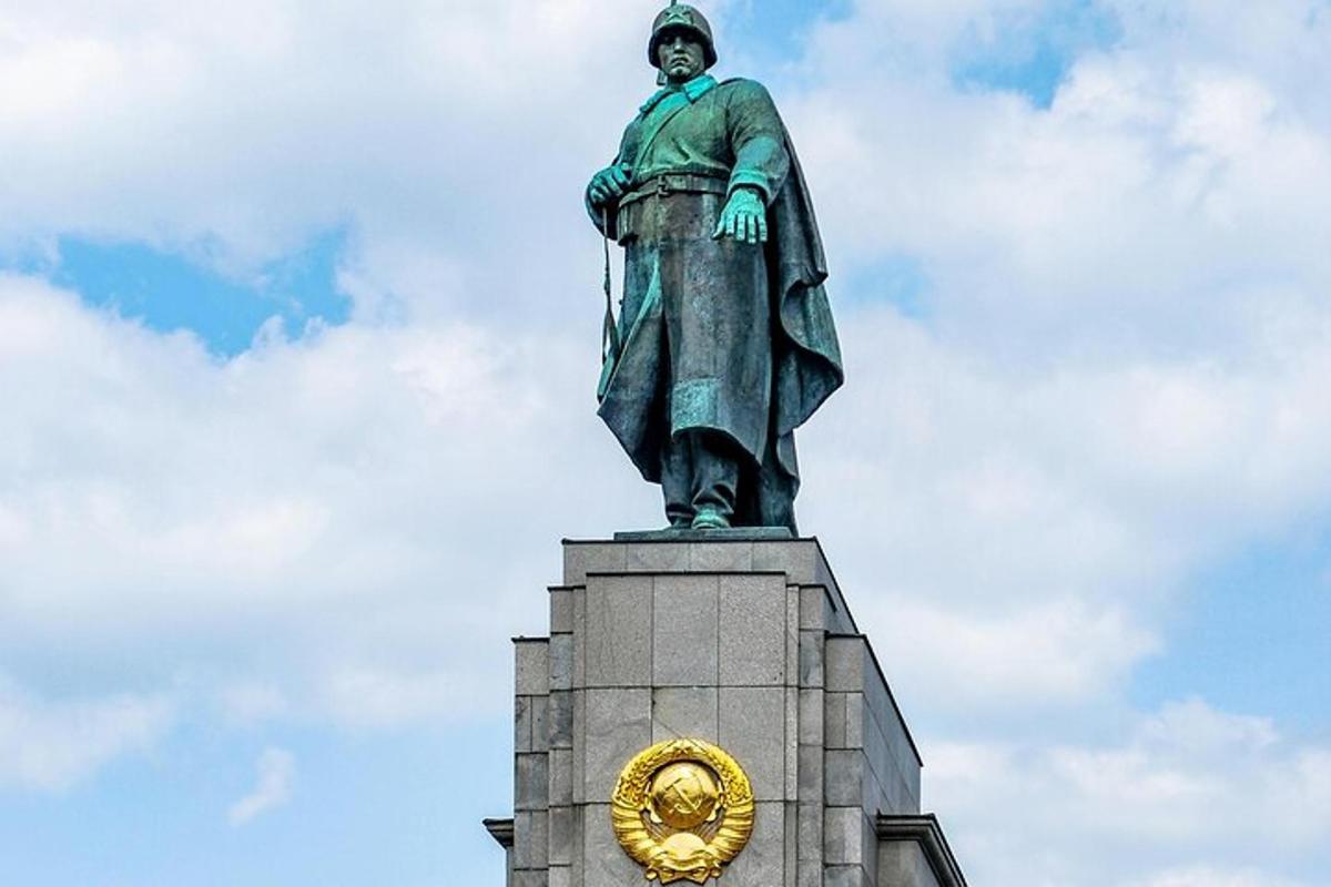 a statue on top of a building with a clock