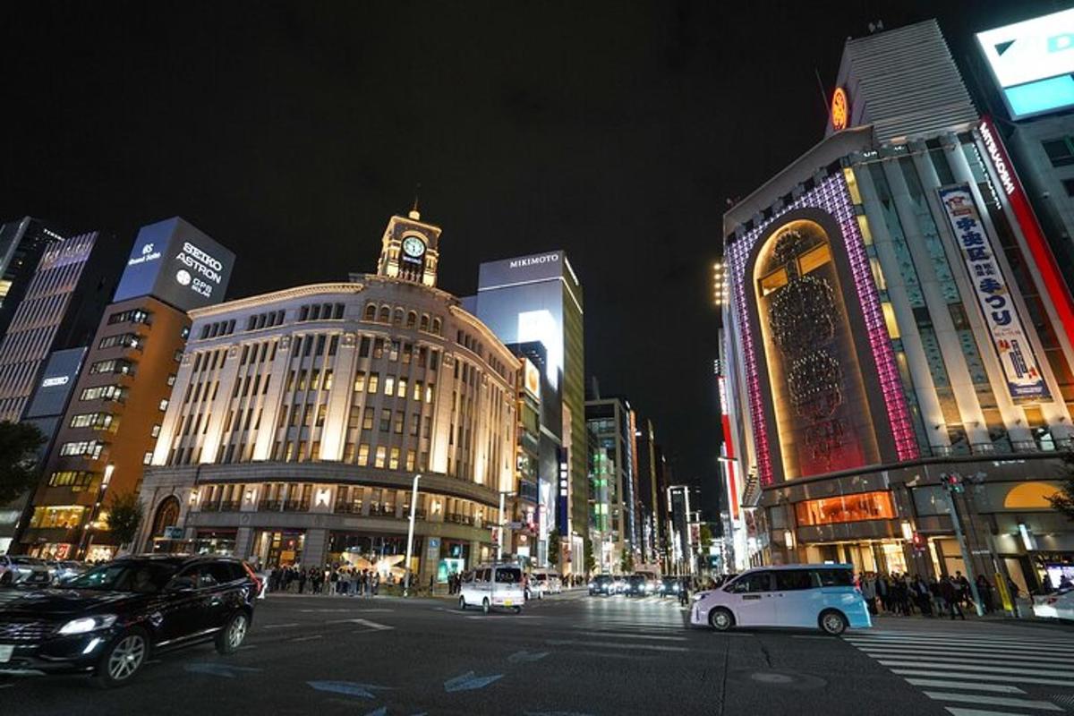 a busy city street at night with cars and buildings