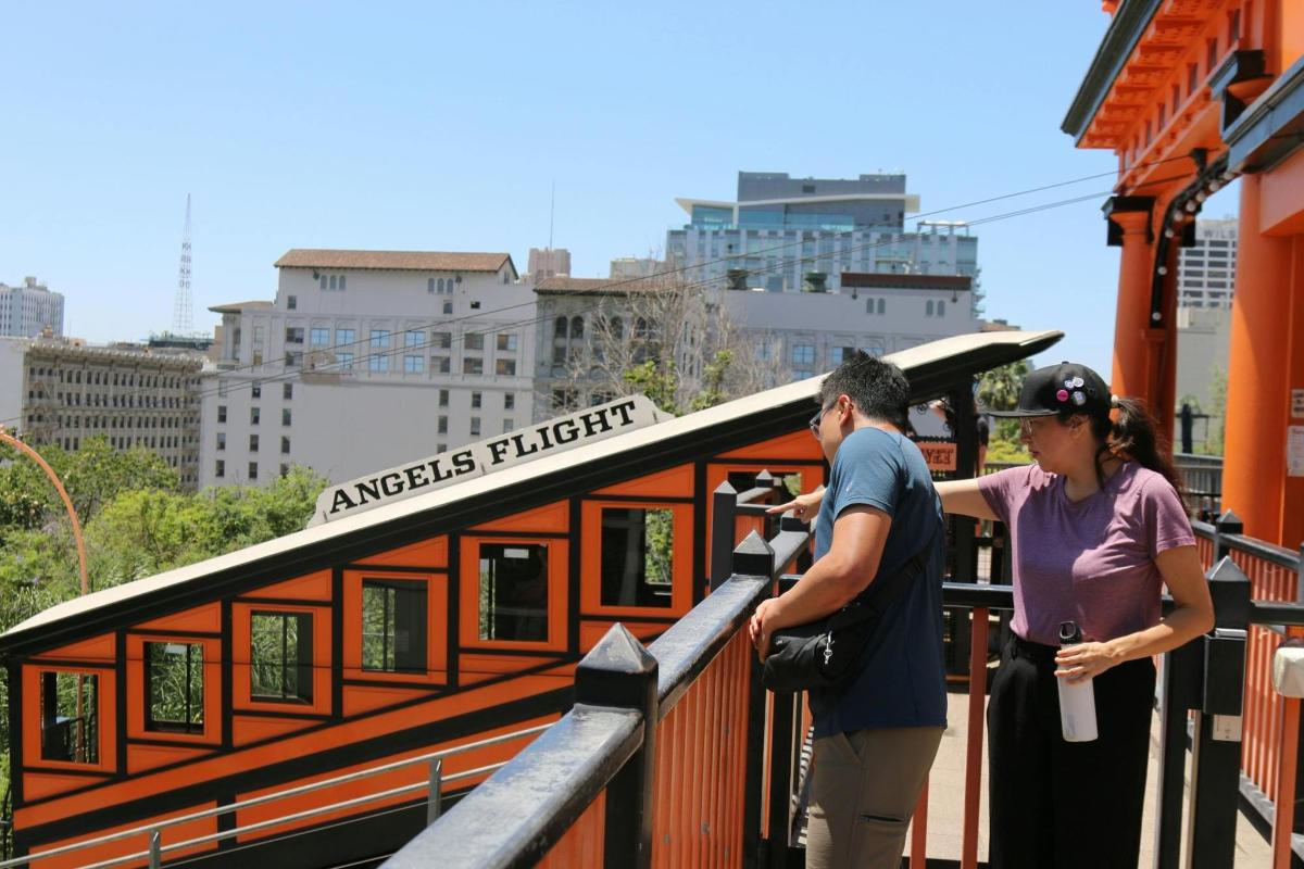a man and a woman looking at a train