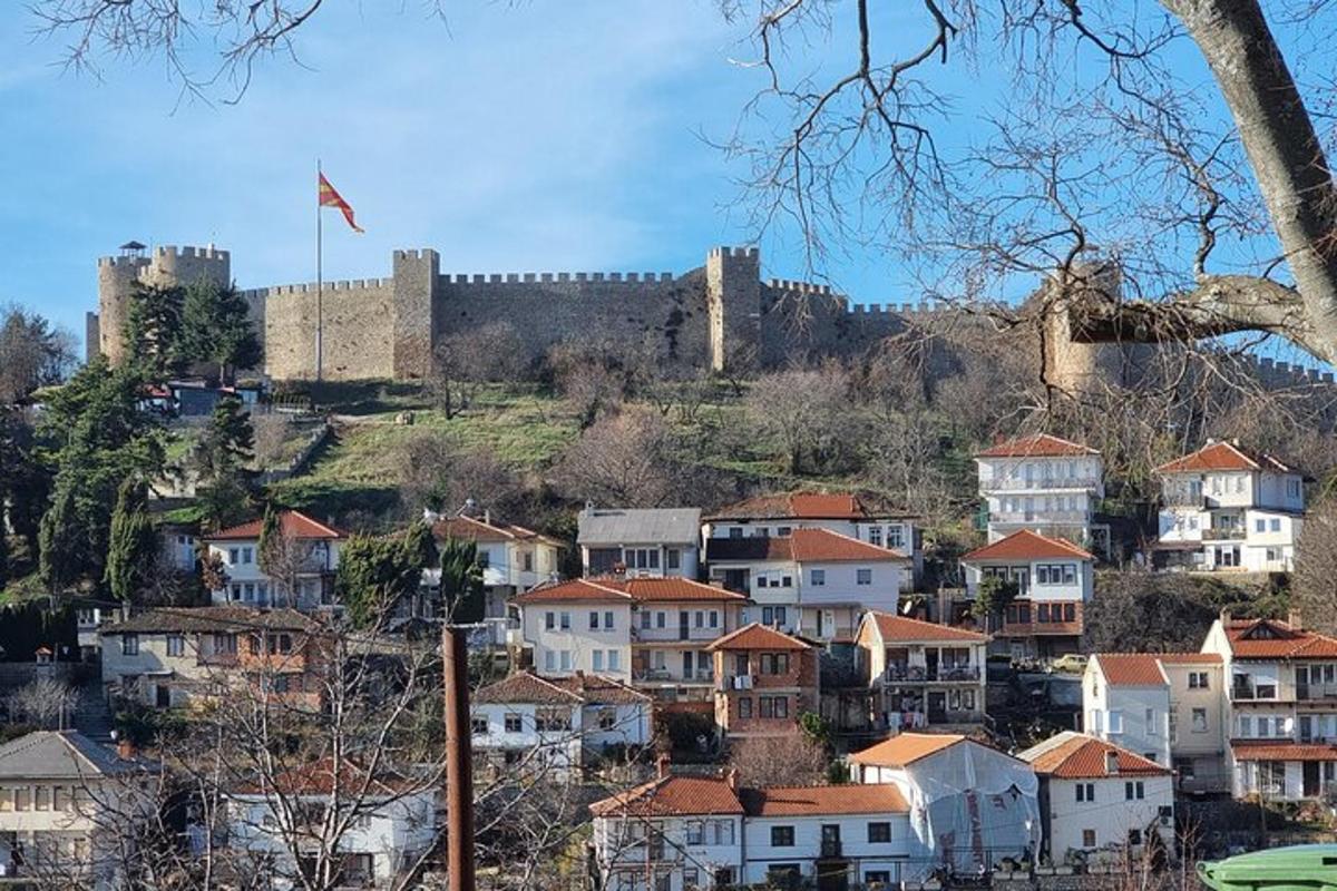 a city with a castle on a hill with houses
