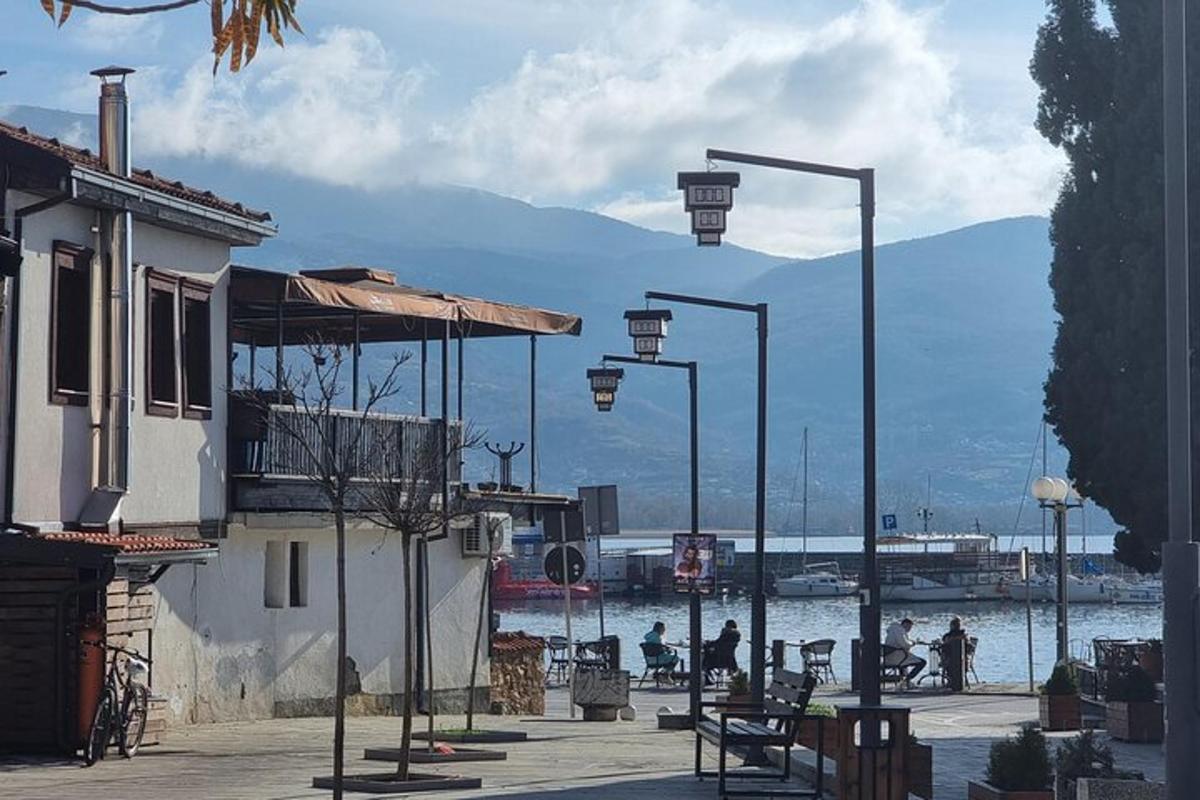 a group of street lights next to a body of water