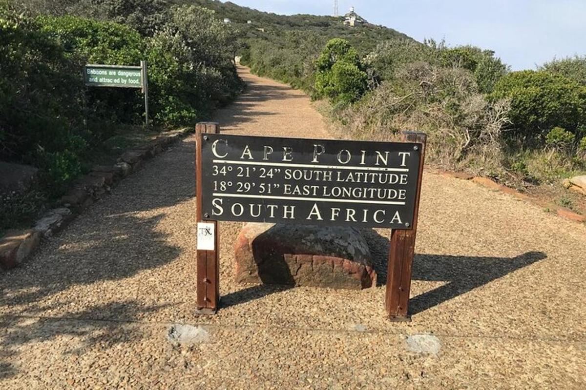 a sign on the side of a dirt road