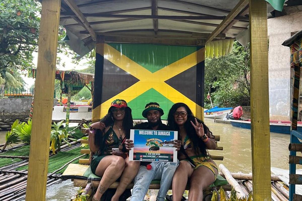 three people sitting on a bench holding a sign