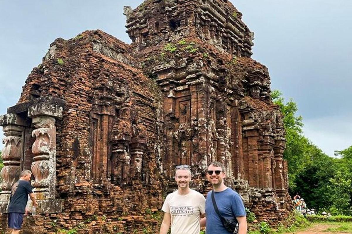 two men standing in front of an old building