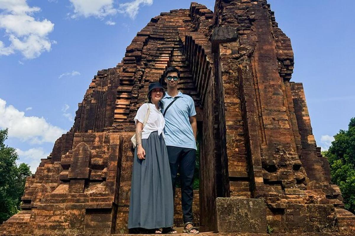 a man and a woman standing in front of a temple