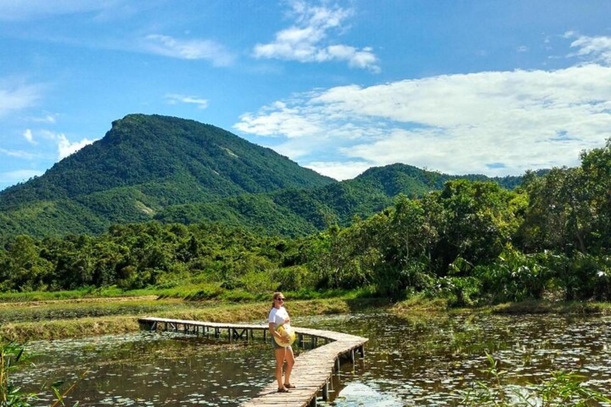 a woman standing on a bridge over a river