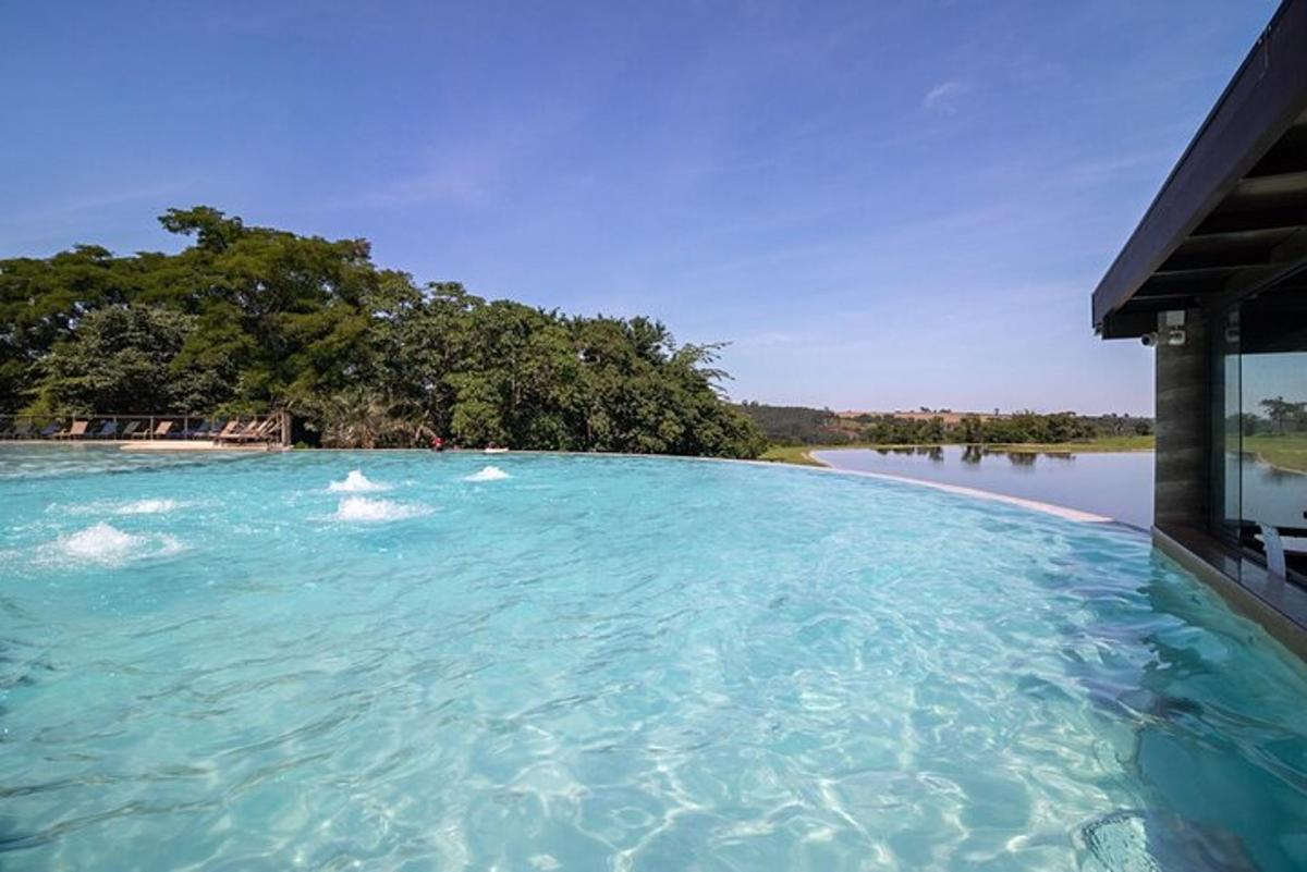 a large pool of blue water next to a river
