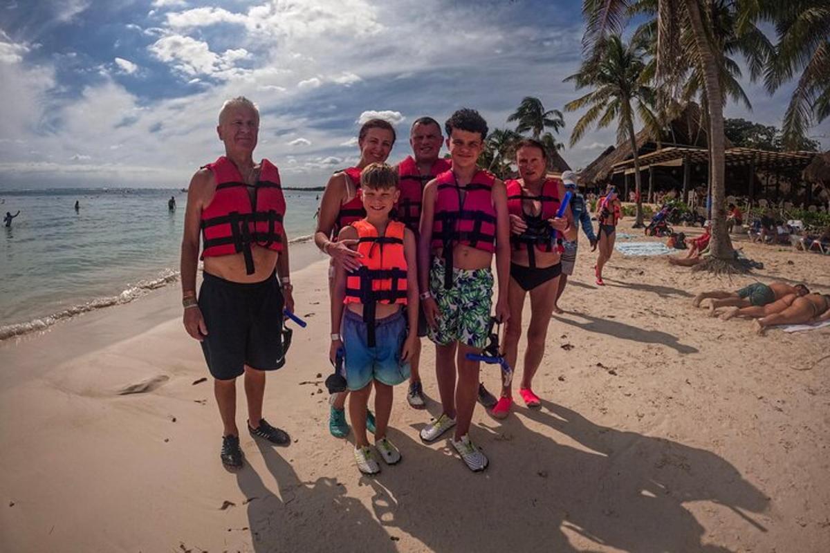 a group of people wearing life jackets on the beach