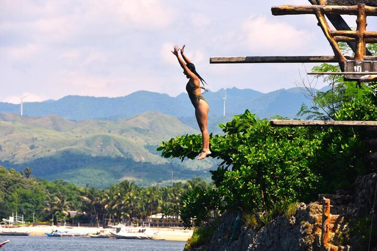 a woman jumping off a cliff into the water
