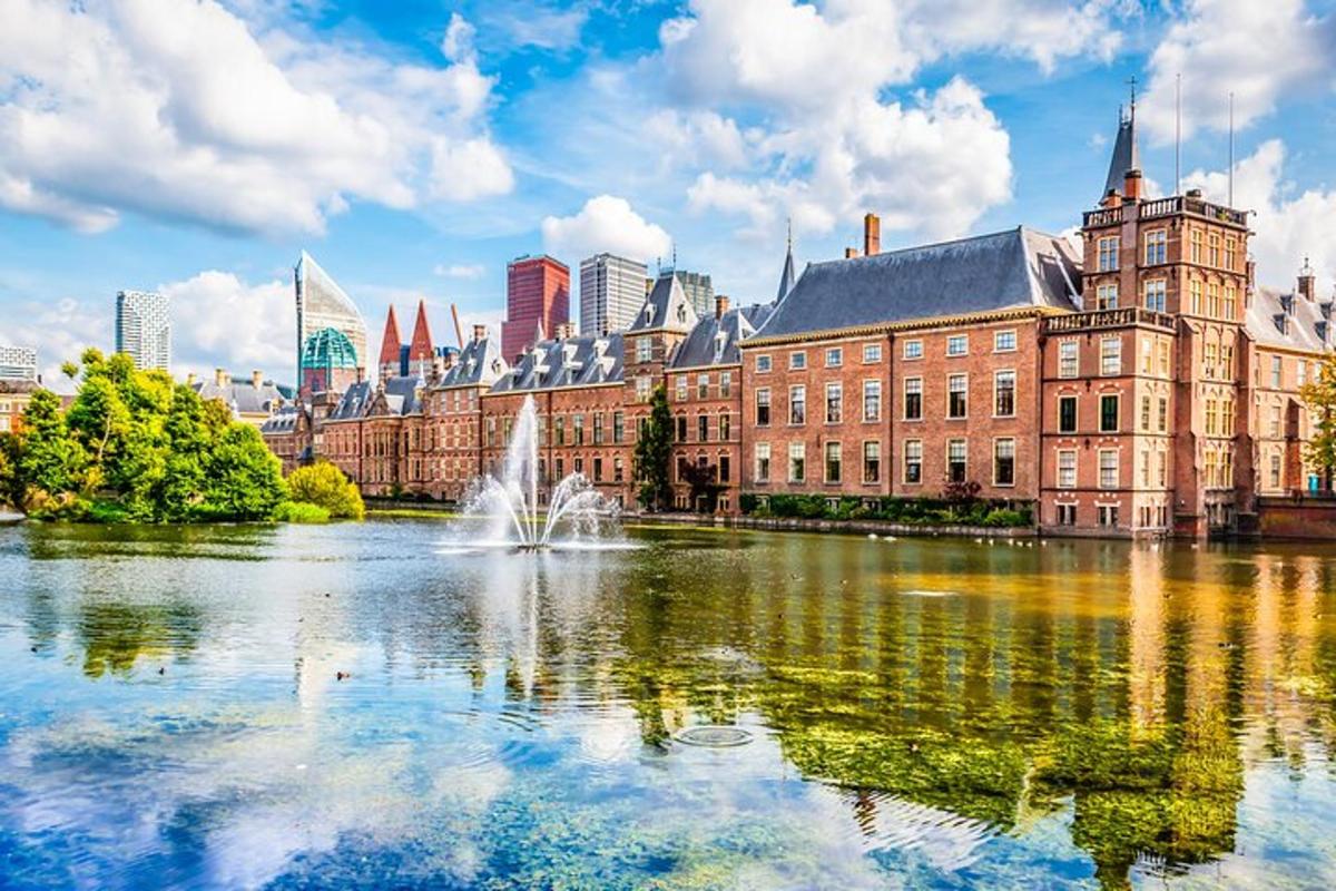 a large building with a pond in front of a city