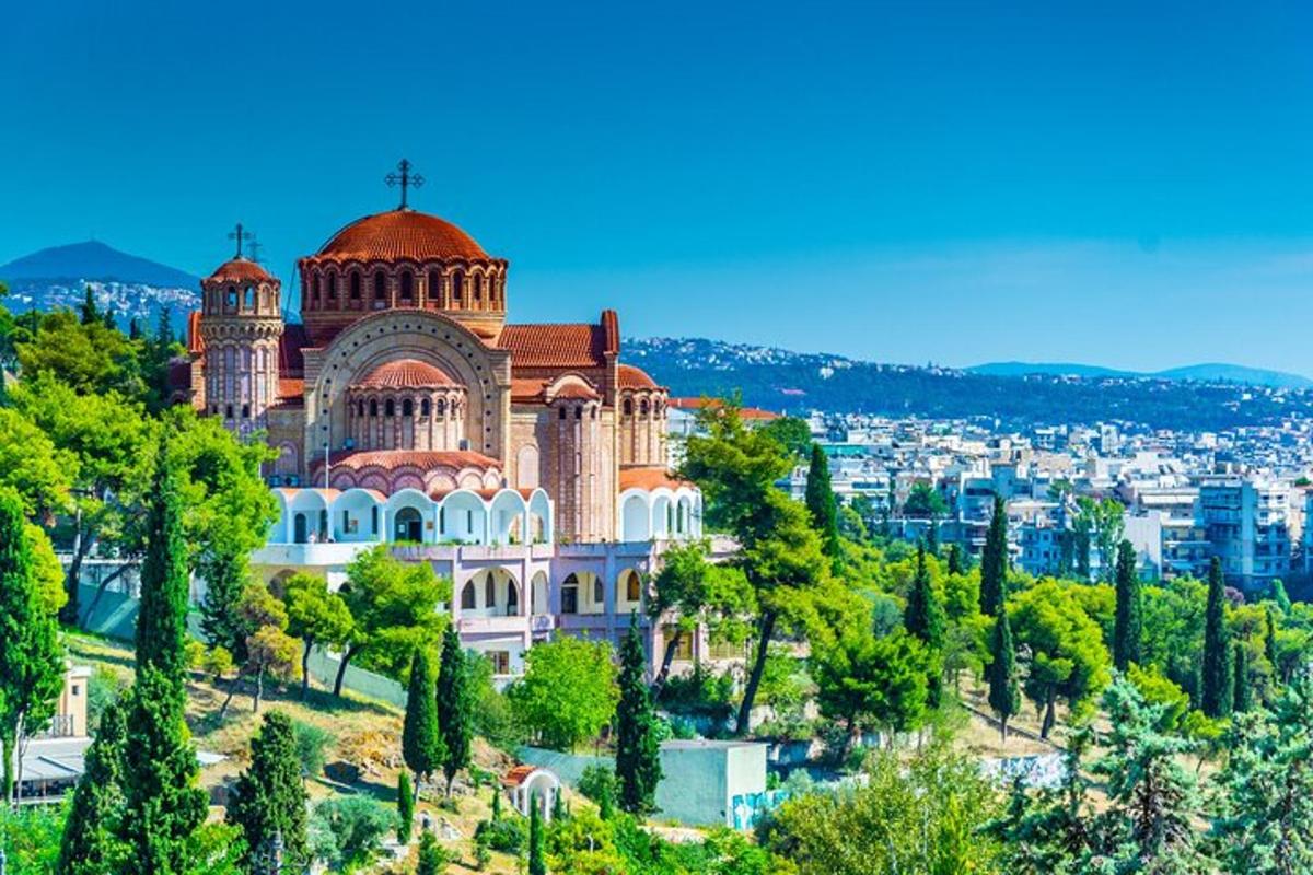 a church on a hill with a city in the background