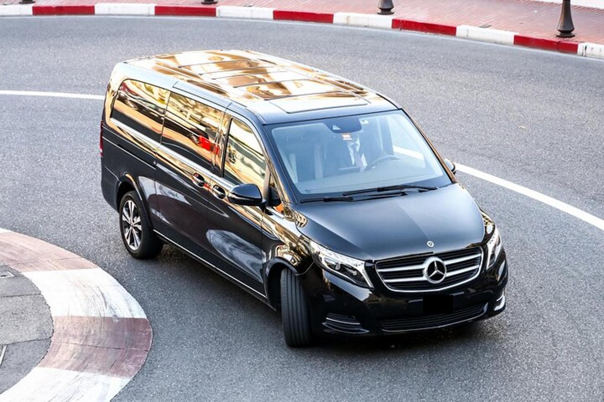 a black and gold suv driving down a street