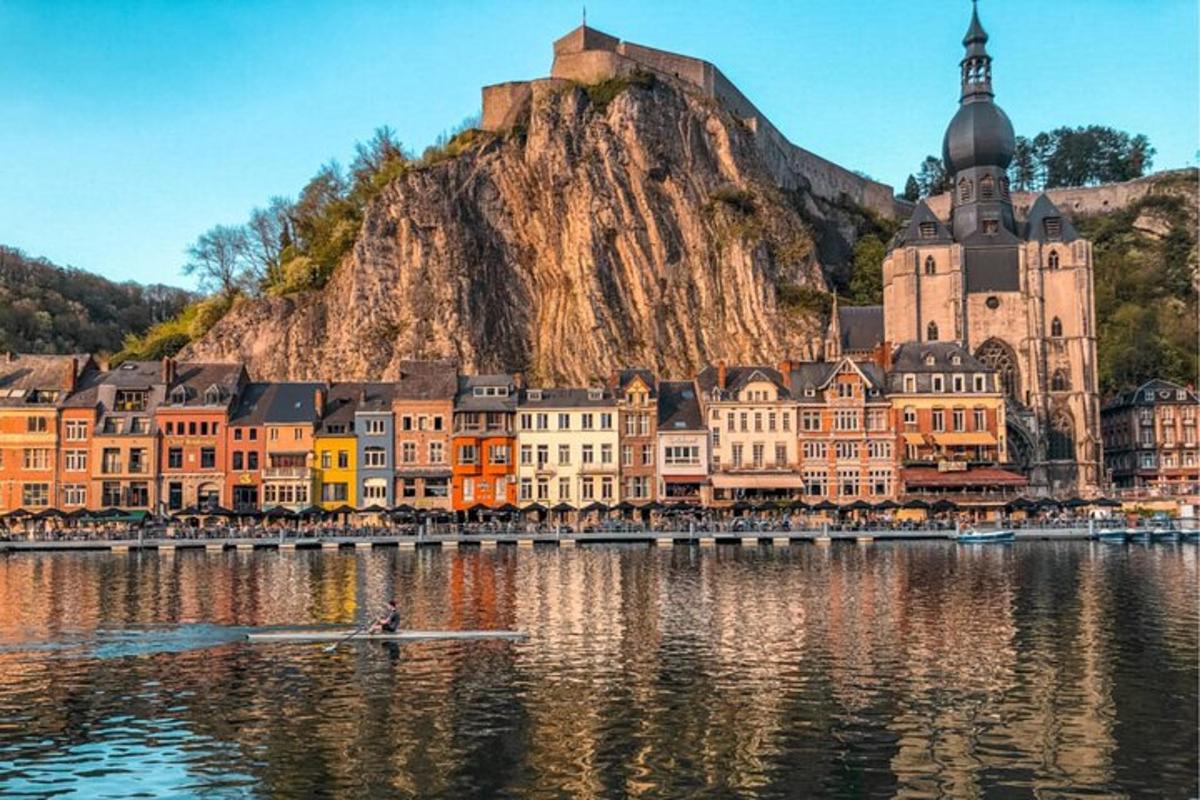 a town on the water in front of a mountain