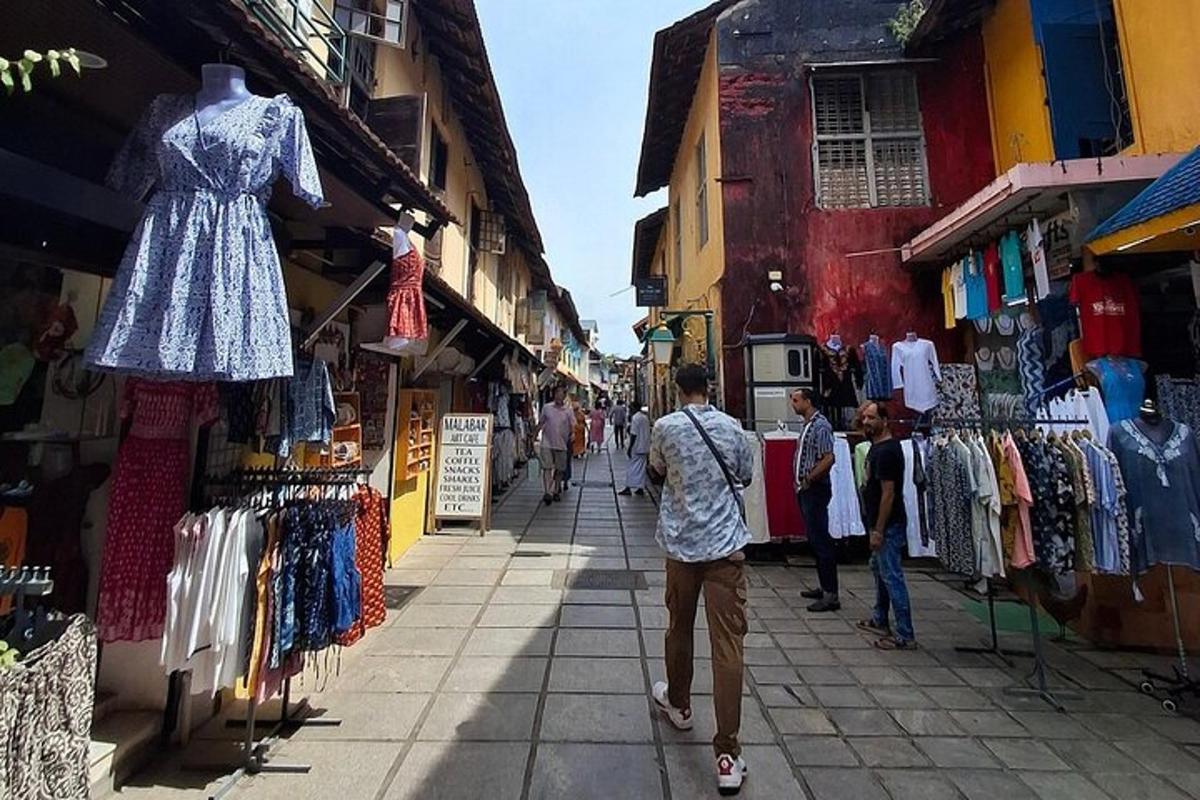 a man walking down a street next to a clothing store